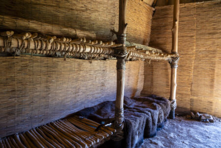 A view of the sleeping bunks in the longhouse.