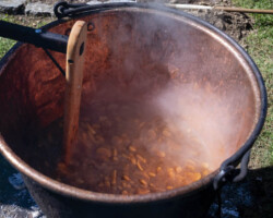 A cauldron of snitz being made into apple butter.